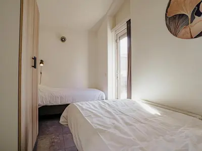 a bedroom with two beds and a window at Waterside Escape with Easy Access in Uitgeest
