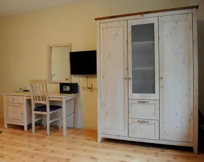 a room with a desk and a cupboard with a computer at Imperial Hotel Amsterdam in Amsterdam