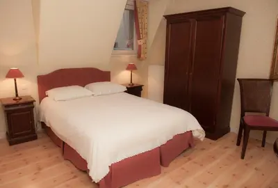 a bedroom with a large bed and a dresser at Imperial Hotel Amsterdam in Amsterdam