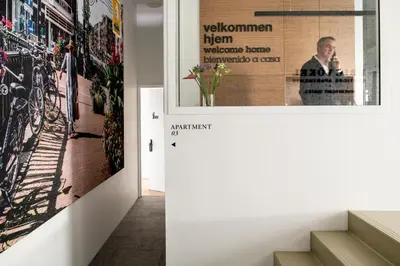 a hallway with a large poster on the wall at Eric Vökel Boutique Apartments - Riverfront Suites in Amsterdam