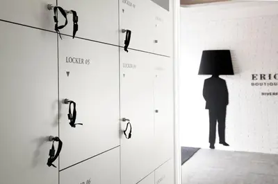 a silhouette of a person with a lamp in a room at Eric Vökel Boutique Apartments - Riverfront Suites in Amsterdam
