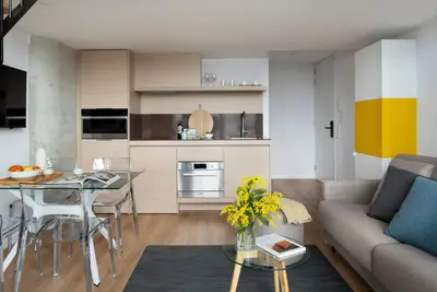 a living room with a couch and a table at Eric Vökel Boutique Apartments - Riverfront Suites in Amsterdam