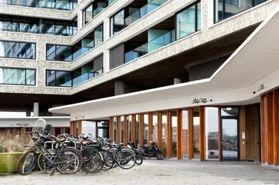 a bunch of bikes parked in front of a building at Eric Vökel Boutique Apartments - Riverfront Suites in Amsterdam