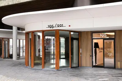 a building with glass doors on the side of it at Eric Vökel Boutique Apartments - Riverfront Suites in Amsterdam