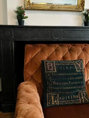 a bed with a pillow next to a mirror at Hotel de Munck in Amsterdam