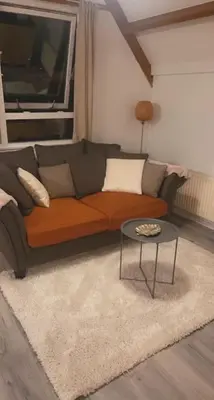 a living room with a couch and a table at Leuke bungalow in Noord-Holland in Opmeer