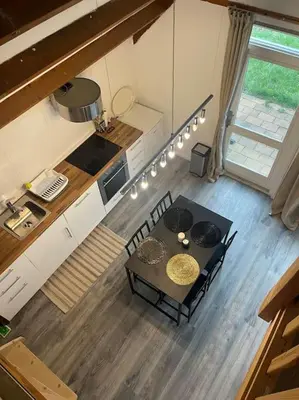 an overhead view of a kitchen with a table and chairs at Leuke bungalow in Noord-Holland in Opmeer