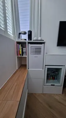 a kitchen with an oven and a book shelf at LIEV Amsterdam Cozy boutique suite in The Pijp in Amsterdam