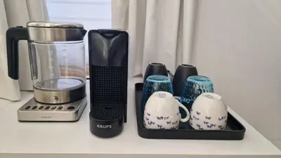 a counter with a blender and cups on it at LIEV Amsterdam Cozy boutique suite in The Pijp in Amsterdam
