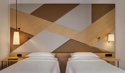 two beds in a room with a ceiling at Sheraton Amsterdam Airport Hotel and Conference Center in Schiphol