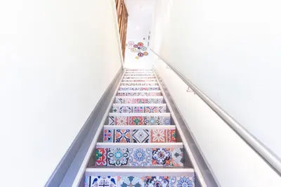an empty staircase with colorful tiles on the stairs at Hotel Pagi in Amsterdam