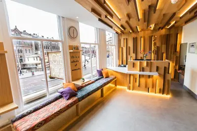 a room with two benches in front of a large window at Hotel Pagi in Amsterdam