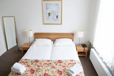 a bedroom with a bed and two tables with lamps at Hotel Verdi in Amsterdam
