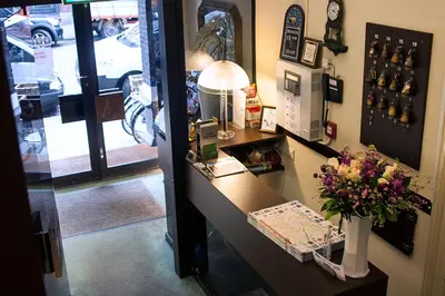a shop with a counter with a vase of flowers at Hotel Verdi in Amsterdam