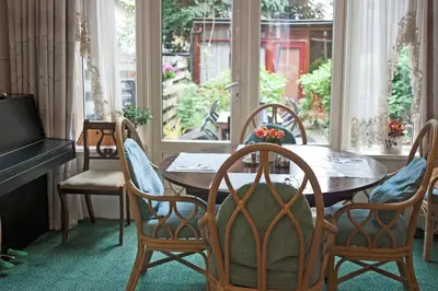 a dining room with a wooden table and chairs at Hotel Verdi in Amsterdam