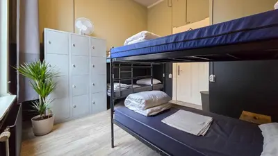 a room with two bunk beds in it at Hostel Cosmos Amsterdam in Amsterdam