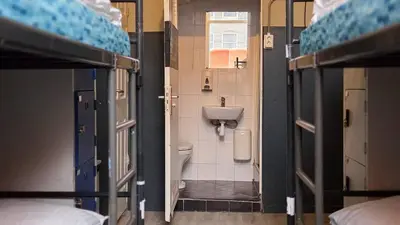 a small bathroom with a toilet and a sink at Hostel Cosmos Amsterdam in Amsterdam