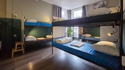 a room with three bunk beds in it at Hostel Cosmos Amsterdam in Amsterdam