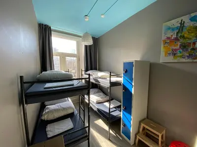 a dorm room with bunk beds and a blue ceiling at Hostel Cosmos Amsterdam in Amsterdam