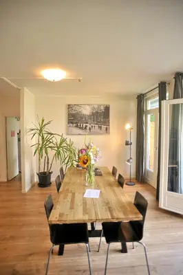 a dining room with a wooden table and chairs at Hotel Abba in Amsterdam