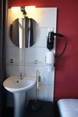 a bathroom with a sink and a mirror at Hotel Abba in Amsterdam