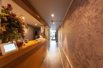 a hallway with a wall with flowers on it at Hotel Hermitage Amsterdam in Amsterdam