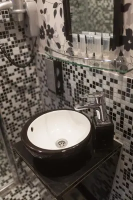 a bathroom with a sink and a mirror at Hotel Hermitage Amsterdam in Amsterdam