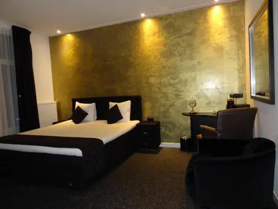 a hotel room with a bed and a chair at Sara's Boutique Hotel in Amsterdam