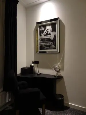 a room with a desk and a chair and a picture at Sara's Boutique Hotel in Amsterdam