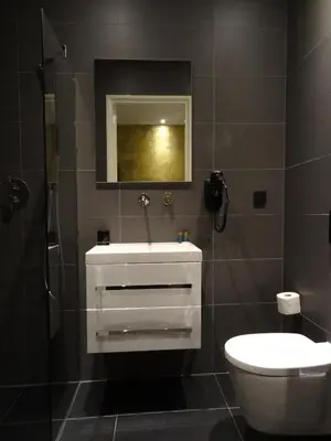 a bathroom with a white sink and a toilet at Sara's Boutique Hotel in Amsterdam