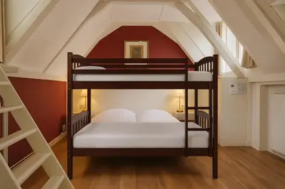 a room with two bunk beds in a attic at Hotel Prinsenhof Amsterdam in Amsterdam