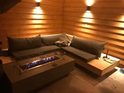 a living room with a couch and a fireplace at Farmvilla with hottub and outdoor kitchen in Beets
