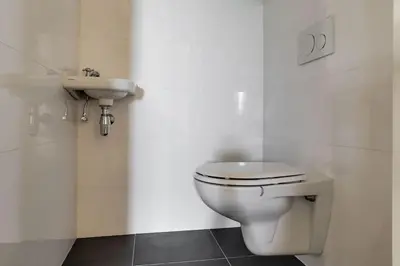 a bathroom with a toilet and a sink at Farmvilla with hottub and outdoor kitchen in Beets