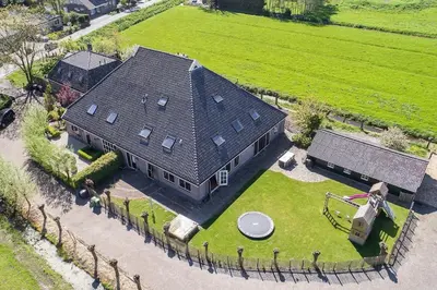 an aerial view of a large house with a yard at Farmvilla with hottub and outdoor kitchen in Beets