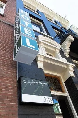 a sign on the side of a building at Hotel The Neighbour's Magnolia in Amsterdam