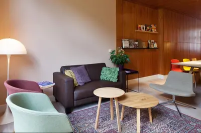a living room with a couch and chairs at Hotel The Neighbour's Magnolia in Amsterdam