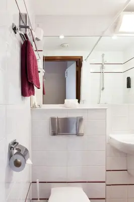 a white bathroom with a sink and a toilet at Hotel The Neighbour's Magnolia in Amsterdam