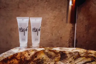 two bottles of hair products sitting on top of a rock at Hajé Nieuwegein in Nieuwegein