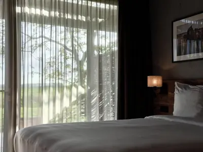 a bedroom with a bed and a large window at Hajé Nieuwegein in Nieuwegein