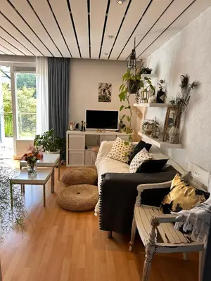 a living room with a couch and a table at Zuidwest Zeven free parking! in Zandvoort