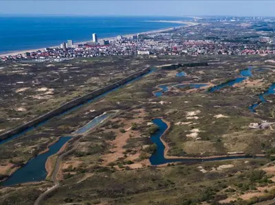 an aerial view of a river and a city at Zuidwest Zeven free parking! in Zandvoort
