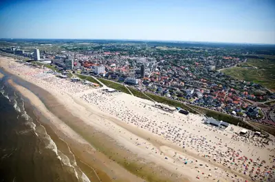 an aerial view of a beach with a crowd of people at Zuidwest Zeven free parking! in Zandvoort