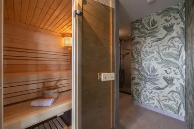 a sauna with wood paneling and a wall at Leonardo Hotel IJmuiden Seaport Beach in IJmuiden
