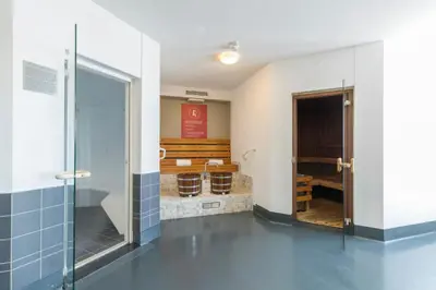 a bathroom with a shower and a glass door at Leonardo Hotel IJmuiden Seaport Beach in IJmuiden