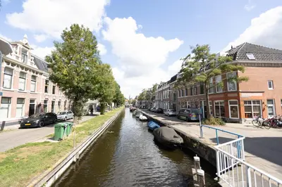 a canal in a city with houses and boats at B&B Brouwersvaart in Haarlem