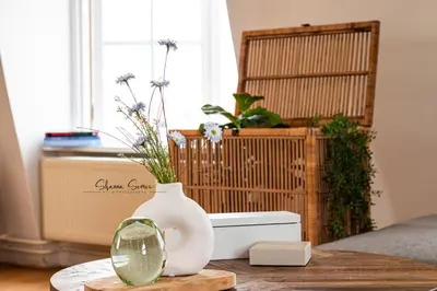 a table with a vase and a mirror on it at ApartHotel Trendy by Urban Home Stay in Alkmaar