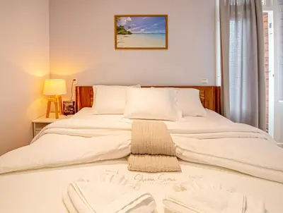 a bed with white sheets and towels on it at ApartHotel Trendy by Urban Home Stay in Alkmaar