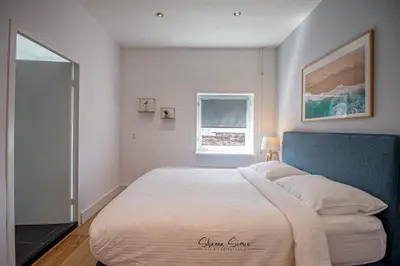 a bedroom with a large bed and a window at ApartHotel Trendy by Urban Home Stay in Alkmaar