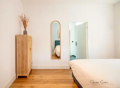 a bedroom with a bed and a mirror at ApartHotel Trendy by Urban Home Stay in Alkmaar