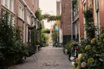 an alley with a bike parked on a street at ApartHotel Trendy by Urban Home Stay in Alkmaar